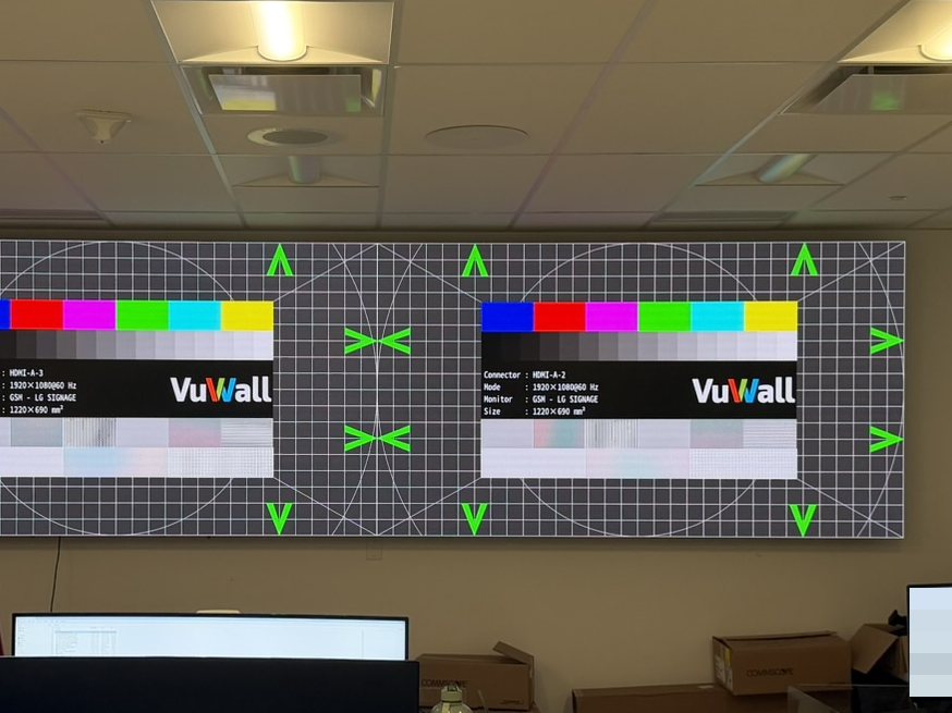 Direct-view LED wall showing a calibration test pattern during fit-out